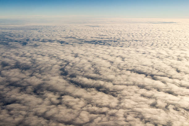 istock Clouds and sky as seen through window of an aircraft/airplane 514163916