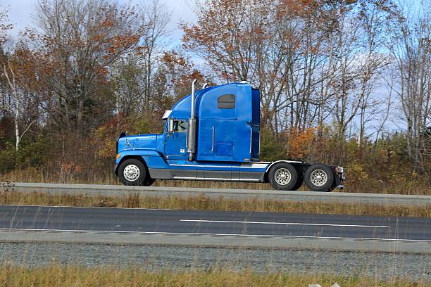 istock Semi truck on a highway, trees in background. 514164220