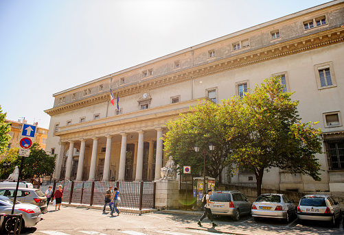 Aix-En-PRovence, France- July 17, 2014: Cour d'appel d'Aix-en-Provence Palace of Justice of Aix-en-Provence on a sunny day with cars and pedestrians. The Palace is located in Place de Verdun