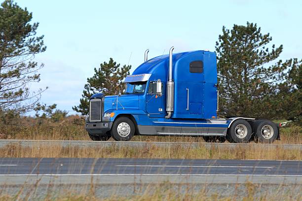 istock Semi truck on a highway, trees in background. 514169402