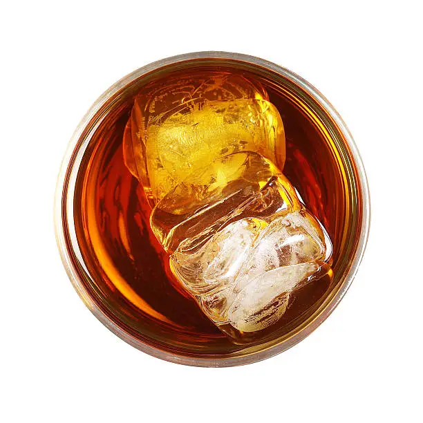 whiskey glass with ice isolated on white background - top view