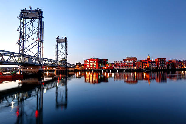 Memorial Bridge in Portsmouth, New Hampshire The Memorial Bridge connecting Portsmouth, New Hampshire, and Badger's Island in Kittery, Maine. Portsmouth is the third oldest city in the United States and is a historic seaport and popular summer tourist destination only 60 miles from Boston portsmouth nh stock pictures, royalty-free photos & images