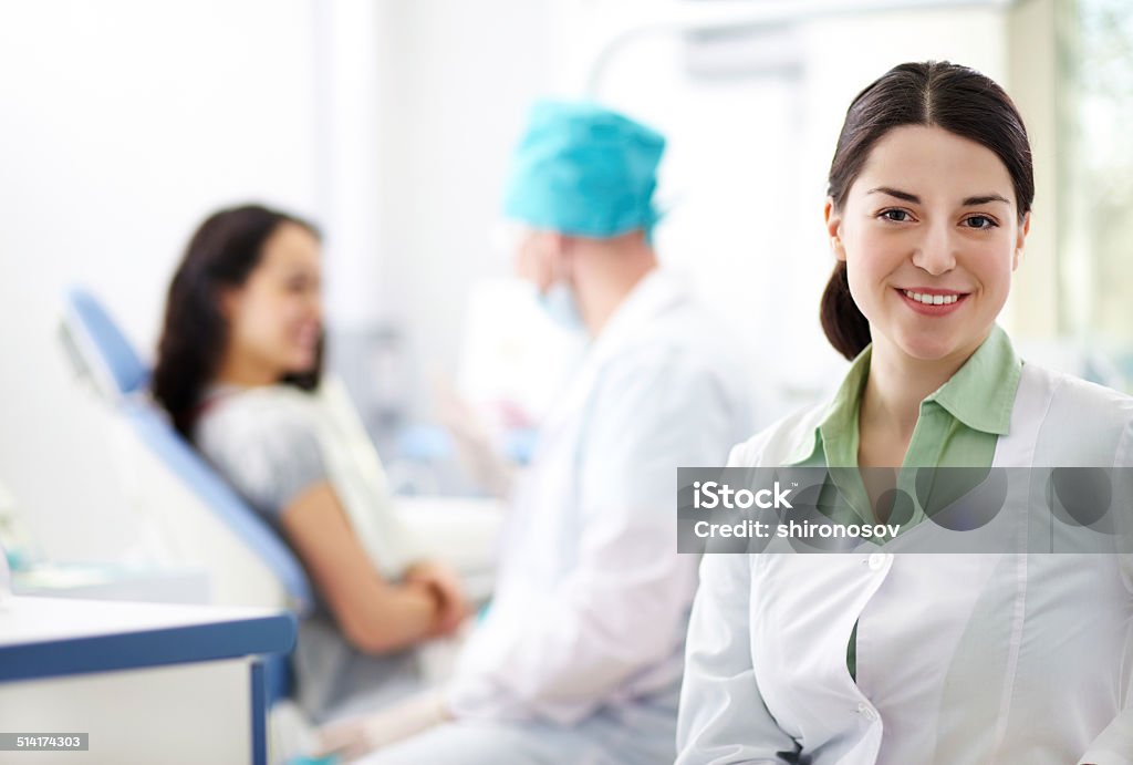 Pretty assistant Pretty assistant looking at camera in the doctors office Adult Stock Photo