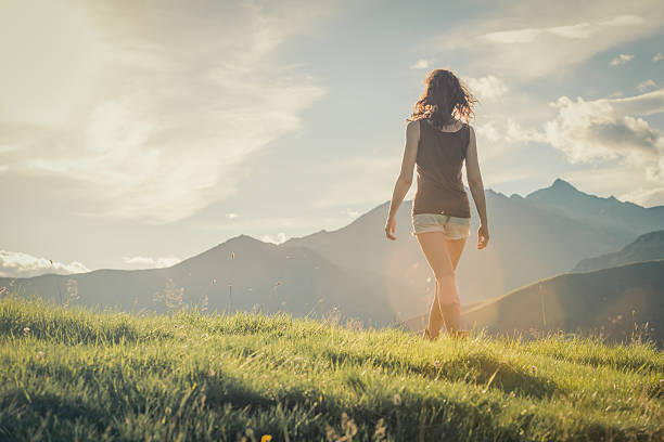 istock Young backside woman walk on mountain in sunny day 514175239