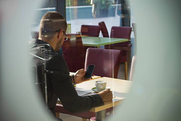 istock Young man looking at the phone, window view 514175461