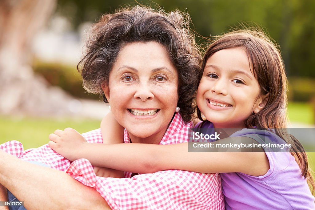 Grandmother And Granddaughter Sitting In Park Together Grandmother And Granddaughter Sitting In Park Together Smiling To Camera Senior Women Stock Photo