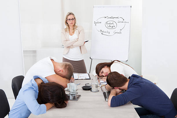 istock Businesswoman Looking At Colleagues Sleeping During Presentation 514176781