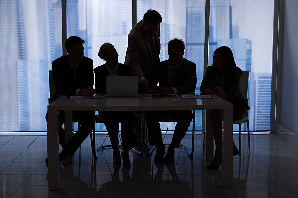 istock Silhouette Business People Discussing In Office 514178373