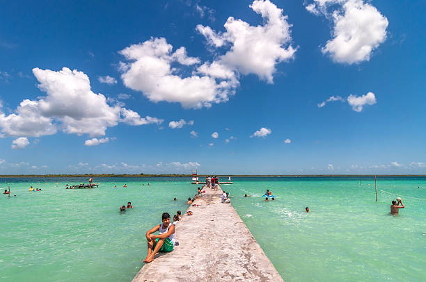 Bacalar, Mexico - April 26, 2014: locals and tourists enjoy turquoise water at Balneario magico in Bacalar lagoon, Mexico. Bacalar is known for its natural caribbean laguna that changes 7 colours