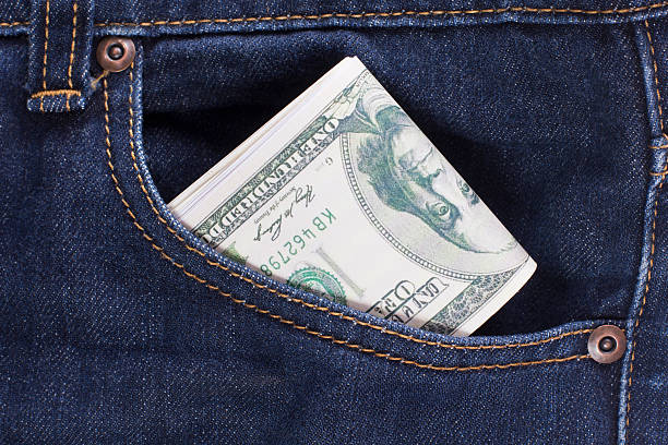 istock dollars in the back jeans pocket 514214089