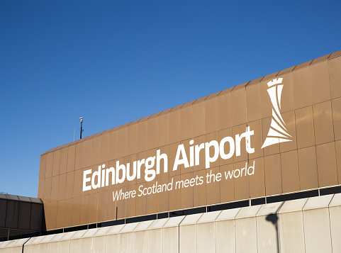 Edinburgh, UK - February 28, 2016: A large sign on the outside of the main terminal building of Edinburgh Airport. The airport is located six miles West of Edinburgh's city centre.