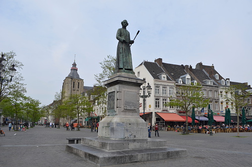 Maastricht, Netherlands, April 12, 2014: View over statue of Beeld van Minckelers on markt in Maastricht, which was famous professor examining behaviour of hot air.
