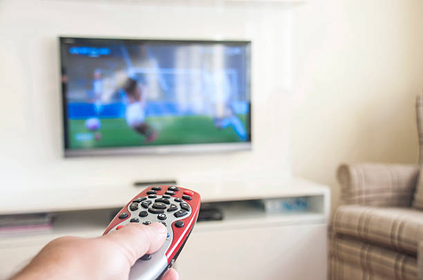 istock Watching soccer on a smart TV remote control in hand 514216830