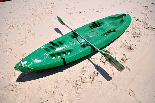 istock Old Green boat on white beach on warm sunset 514216836