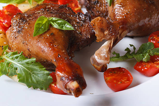 istock roasted duck legs with tomato and arugula macro horizontal 514217733