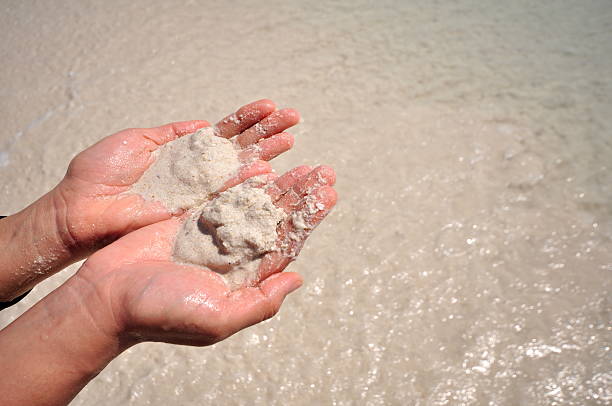 istock Young woman with sand in hands 514218068