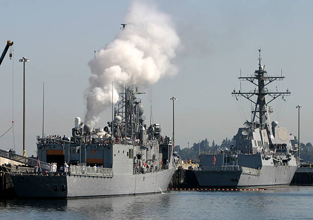 military ships prepare to leave harbor stock photo