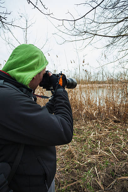 istock Wildlife photographer working at lake 514218336