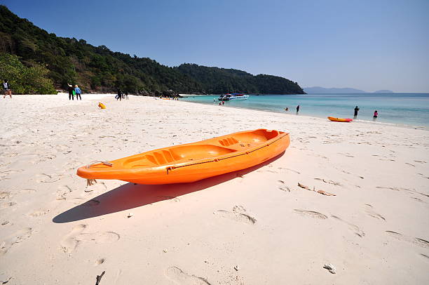 istock Old Orange boat on white beach on warm sunset 514219284