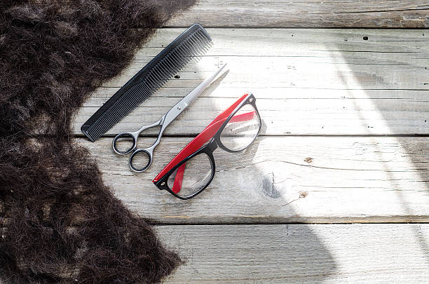 istock Hair on the bunch with glasses, scissors and comb 514221124