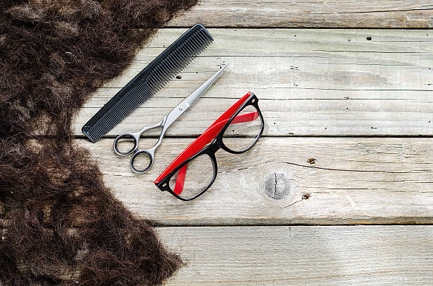 istock Hair on the bunch with glasses, scissors and comb 514221360