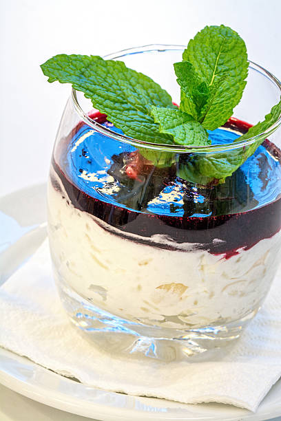sweet rice desert sweet rice cream desert with raspberry sauce and mint on white background beatifull stock pictures, royalty-free photos & images