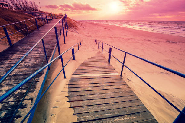 istock Stairway to the sandy beach at sunset 514225846