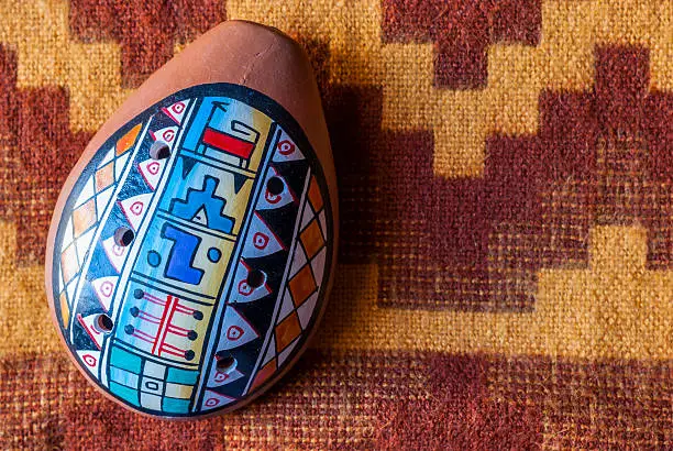 Photo of Close-up peruvian ocarina on an alpaca wool blanket