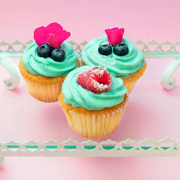istock Cupcakes with butter cream and vanilla with raspberry and blueberry 514226098