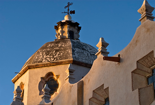 The light shines softly on a historical mexican church