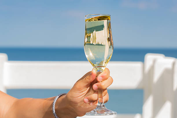 istock glass of champagne in his hand 514228478