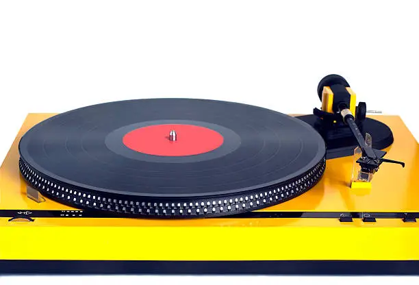 Turntable in yellow case with black vinyl record with empty label on disc with stroboscope marks isolated on white background. Horizontal black and white photo front view closeup