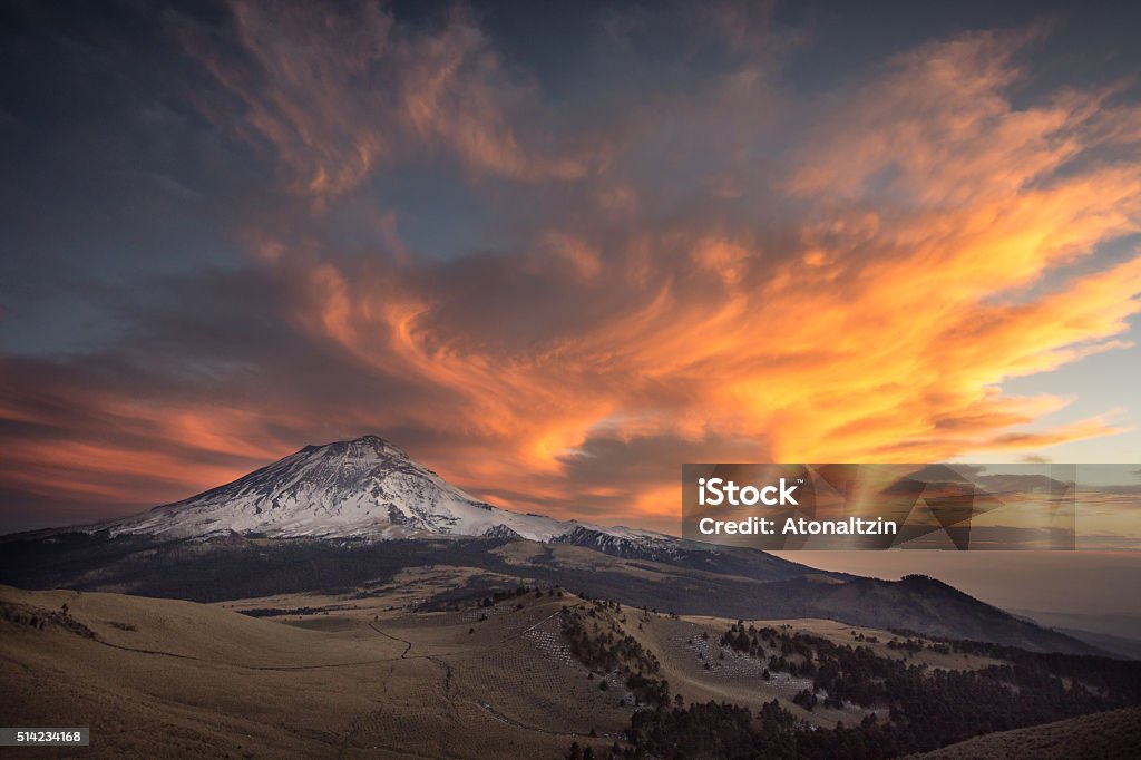 Between Ice and Fire Sunset over the Popocatepetl volcano seen from the Iztaccihuatl volcano. Popocatepetl Volcano Stock Photo
