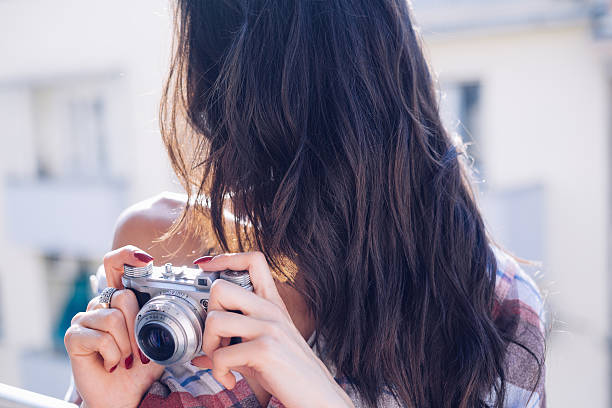 istock Female photographer checking camera 514235030