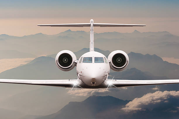 istock Airplane fly over clouds and Alps mountain on sunset. Front 514235176