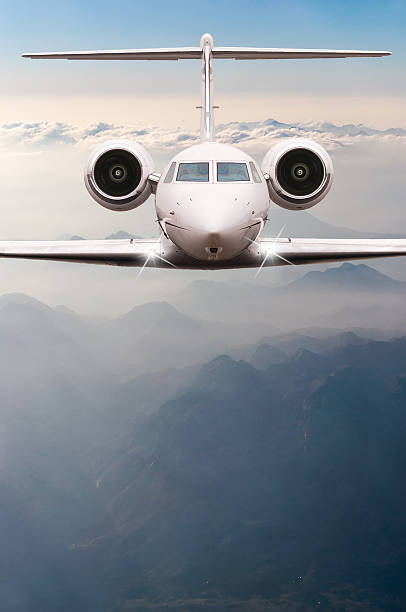 istock Airplane fly over clouds and Alps mountain on sunset. Front 514235188