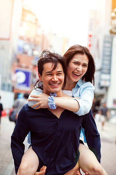 istock Happy young asian couple having fun with piggy back 514235454