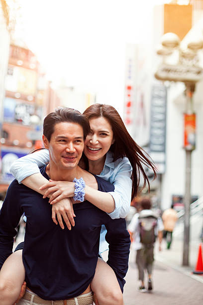 istock Happy young asian couple having fun with piggy back 514235576