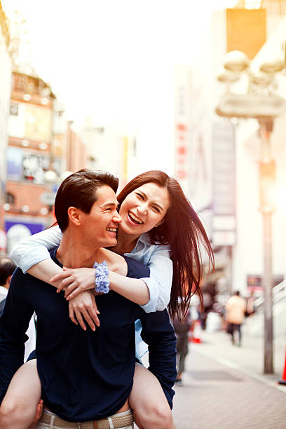 istock Happy young asian couple having fun with piggy back 514235616