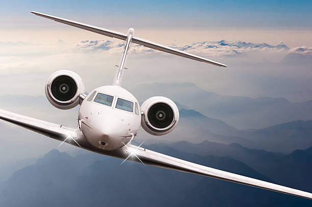 istock Airplane fly over clouds and Alps mountain on sunset. Front 514235688