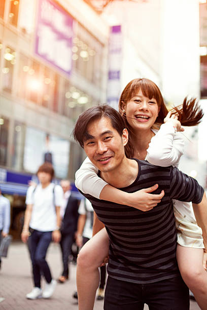 istock Happy young asian couple having fun with piggy back 514235802