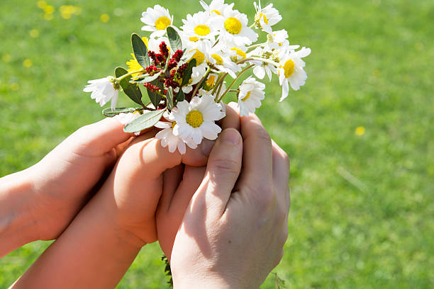 istock Mother and your child holding a beatiful spring flower bouquet. 514236426