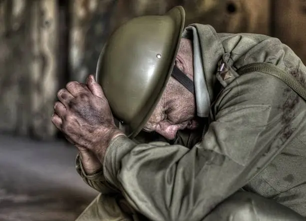 soldier with his head in his hands