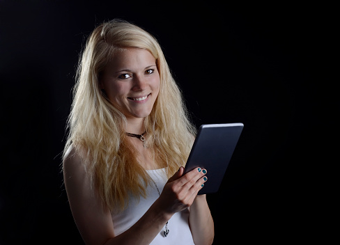 laughing young blond woman with digital tablet