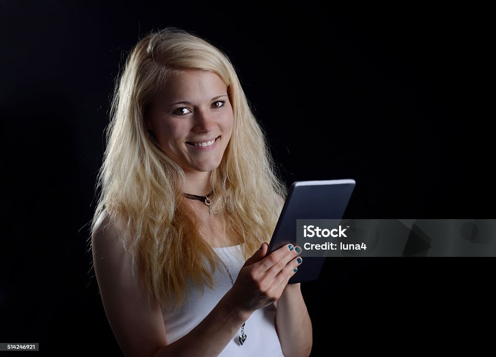 woman with digital tablet laughing young blond woman with digital tablet Adolescence Stock Photo