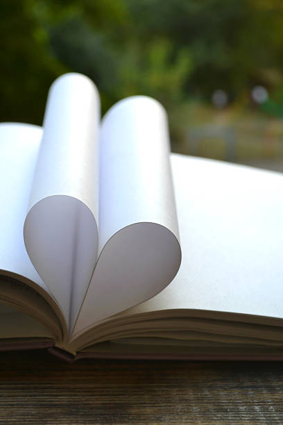 istock Book pages curved into a shape of heart 514247233