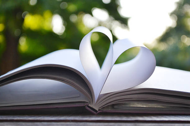 istock Book pages curved into a shape of heart 514247245