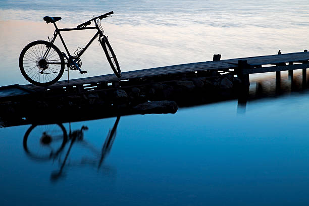 istock Silhouette of a bicycle reflecting on the water 514251191