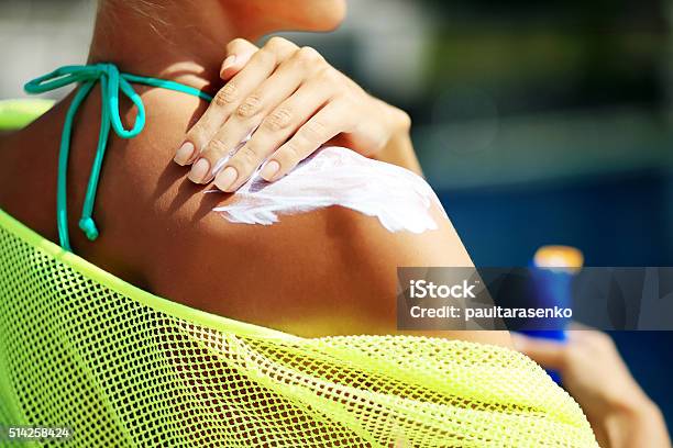Woman Applying Sunblock Protection On Shoulders Stock Photo - Download Image Now - Suntan Lotion, Applying, Sunlight
