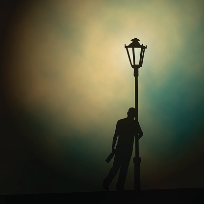 EPS10 editable vector illustration of a drunken man leaning against a lamp-post at night made using a gradient mesh
